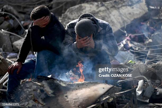 Family members react through the rubble of buildings in kahramanmaras, near the quake's epicentre, after a 7.8-magnitude earthquake struck the...