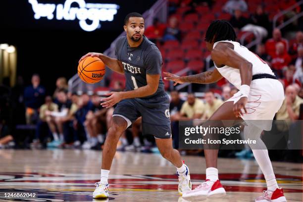 Georgia Tech Yellow Jackets guard Kyle Sturdivant looks into the defensed as he is defended by Louisville Cardinals guard Mike James during a mens...