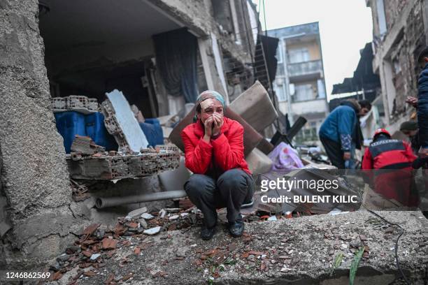 An earthquake survivor reacts as rescuers look for victims and other survivors in Hatay, the day after a 7.8-magnitude earthquake struck the...
