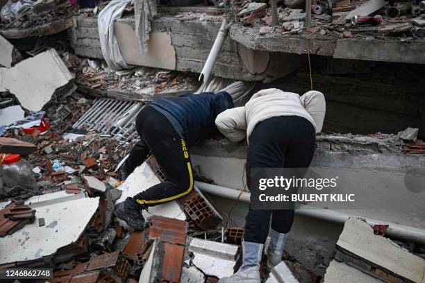 Earthquake victims try to look for their relatives in Hatay, the day after a 7.8-magnitude earthquake struck the country's southeast on February 7,...