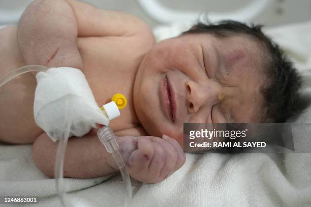 Graphic content / A newborn baby who was found still tied by her umbilical cord to her mother and pulled alive from the rubble of a home in northern...