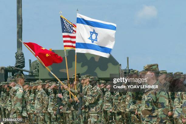 Army soldiers, operators of the Air Defence Patriot system set up to protect Israel against a possible Iraqi Scud missile attack, salute with the...
