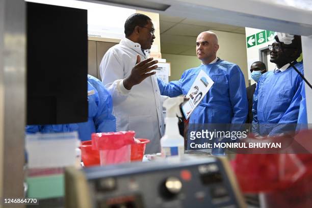 Swiss President Alain Berset tours the Botswana Harvard AIDS Institute in Gaborone, on February 7, 2023 guided by Dr. Sikhulile Moyo , the Zimbabwean...