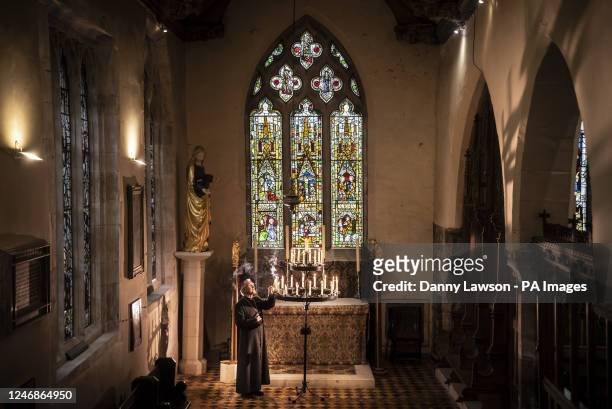 The Rt Reverend Glyn Webster lights a candle in front of the newly restored Lady Chapel East Window at All Saints North Street in York, one of...