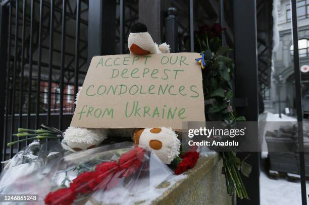 People lay flowers to the Turkish Embassy in memory victims of the Turkish earthquakes in Kyiv, Ukraine on February 07, 2023. The Turkish flag near...