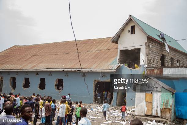 Protesters are seen attacking a Pentecostal church allegedly run by Rwandophone Banyamulenge, during a demonstration against the East Africa...