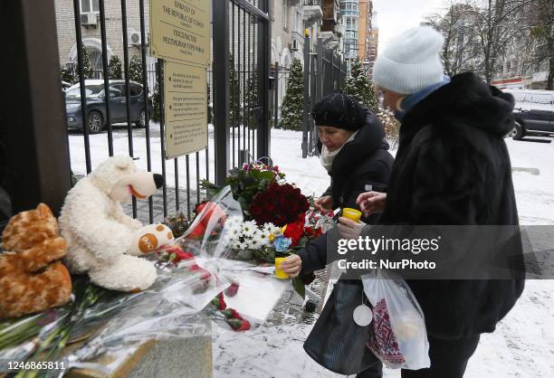 Women places candles as they pay tribute to the victims of the earthquake in Turkey and Syria, outside of the Turkish embassy in Kyiv, Ukraine 07...