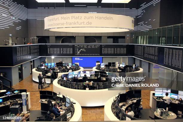 Display shows the German Stock Market Index DAX while brokers are at work at the Frankfurt Stock Exchange in Frankfurt am Main, western Germany, on...