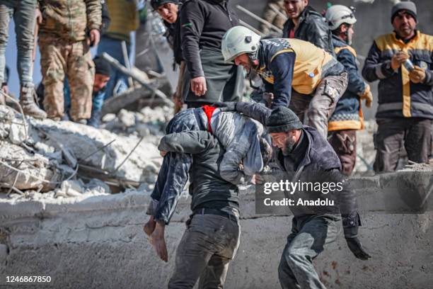 Man carries the dead body of a child who died under the rubble in the earthquake in Idlib, Syria after 7.7 and 7.6 magnitude earthquakes hits...