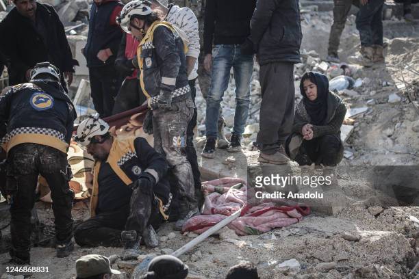 Girl waits to receive news from her relatives who are under the rubble as personnel and civilians conduct search and rescue operations in Afrin...