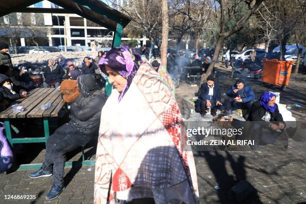 People gather outside in Gaziantep, close to the quake's epicentre, a day after a 7.8-magnitude earthquake struck the country's southeast, on...