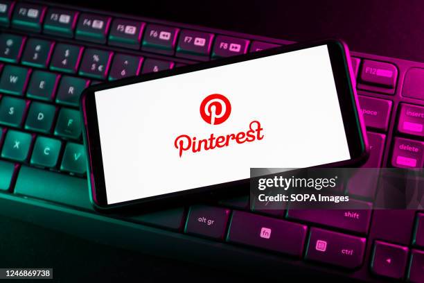 In this photo illustration a Pinterest logo seen displayed on a smartphone.