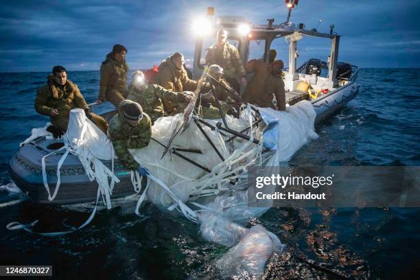 Sailors assigned to Explosive Ordnance Disposal Group 2 recover a high-altitude surveillance balloon on February 5, 2023 off the coast of Myrtle...