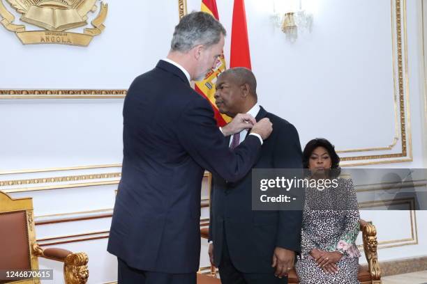 King Felipe VI of Spain pins a decoration on Angolan President Joao Manuel Goncalves Lourenco lapel as Lourenco's wife Ana Afonso Dias Lourenco...
