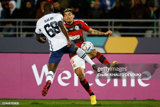 Hilal's defender Saud Abdulhamid marks Flamengo's Brazilian defender Ayrton Lucas during the FIFA Club World Cup semi-final football match between...