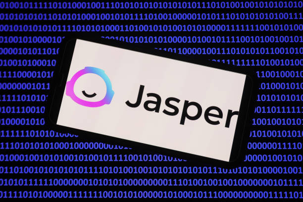 Jasper logo displayed on a phone screen and a binery code displayed on a laptop screen are seen in this illustration photo taken in Krakow, Poland on...
