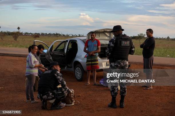 Military police check vehicles in an effort to arrest illegal miners leaving Yanomami Indigenous land on the RR-205 road, in front of the Sucuba...