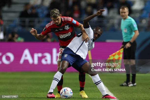 Flamengo's Brazilian defender Ayrton Lucas marks Hilal's defender Saud Abdulhamid during the FIFA Club World Cup semi-final football match between...