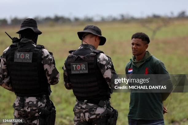 Military police check vehicles in an effort to arrest illegal miners leaving Yanomami Indigenous land on the RR-205 road, in front of the Sucuba...