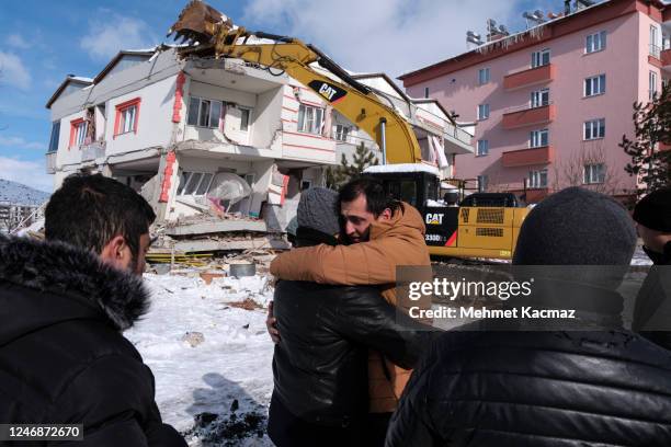 Relatives of earthquake victims react in front of a debris during search and rescue operations in the aftermath of a powerful earthquake in the...