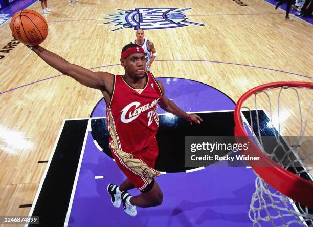 LeBron James of the Cleveland Cavaliers goes for a dunk against the Sacramento Kings during the NBA game at the Arco Arena on October 29, 2003 in...