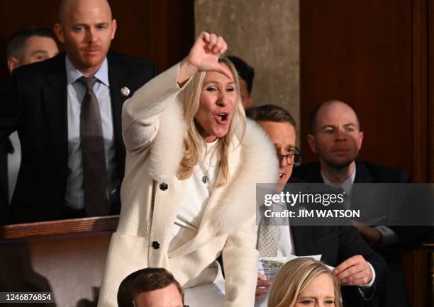 Republican Representative Marjorie Taylor Greene gives a thumb down as US President Joe Biden delivers the State of the Union address at the US...