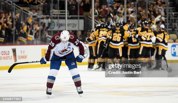 Nathan MacKinnon of the Colorado Avalanche skates off the ice as the Pittsburgh Penguins celebrate a 2-1 win in overtime during the game at PPG...