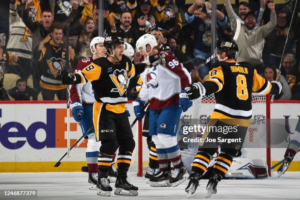 Kris Letang of the Pittsburgh Penguins celebrates his overtime goal with teammates against the Colorado Avalanche at PPG PAINTS Arena on February 7,...