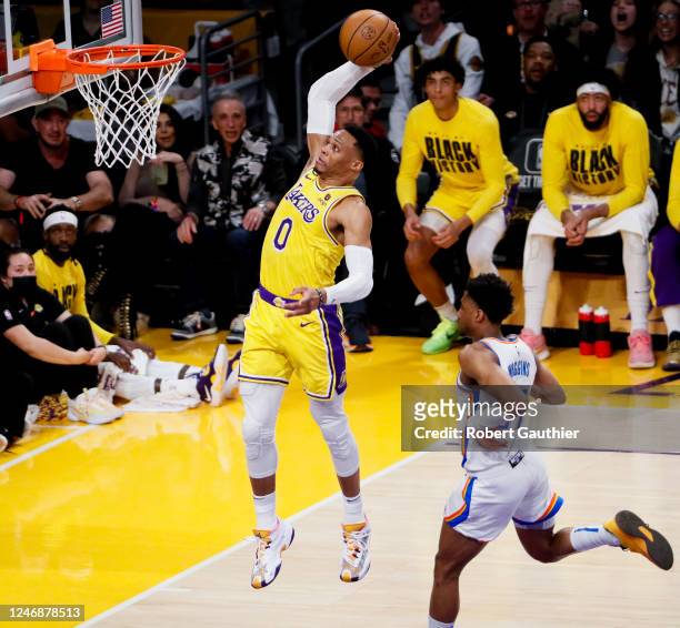 Los Angeles Lakers guard Russell Westbrook dunks the ball ahead of Oklahoma City Thunder guard Aaron Wiggins during the second quarter at Crypto.com...