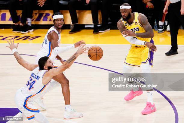 Los Angeles Lakers forward LeBron James passes the ball while Oklahoma City Thunder forward Kenrich Williams stretches for the ball during the second...