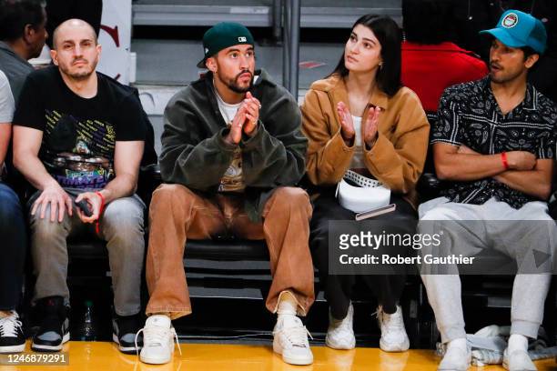 Musician Bad Bunny watches from the sidelines during the second quarter between the Los Angeles Lakers and the Oklahoma City Thunder at Crypto.com...