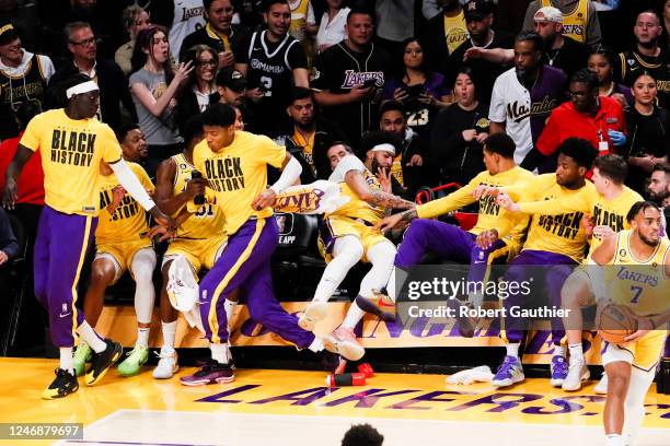 Los Angeles Lakers forward Anthony Davis falls into the bench after saving the ball for a fast break against the Oklahoma City Thunder during the...