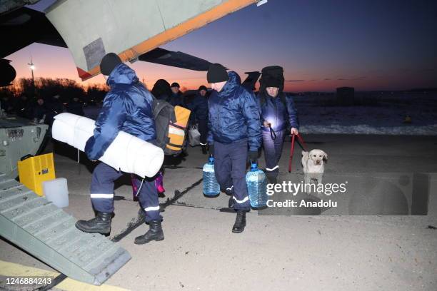 Rescue dog and other rescuers are seen ahead of departure of Belarusian rescuer plane from Minsk, Belarus to arrive flew quake-hit regions in Turkiye...