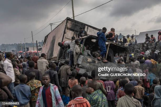 Residents dismantle a vehicle belonging to the United Nations Stabilization Mission in the Democratic Republic of Congo in Kanyaruchinya, Nyiragongo...