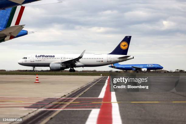 An Airbus SE A320-200 passenger aircraft, operated by Deutsche Lufthansa AG, left, and passenger aircrafts, operated by ITA Airways, at Fiumicino...