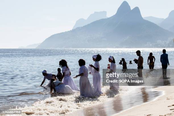 Devotees pray and jump waves in celebration of Iemanjá, the west-African goddess of the sea. In the event modeled after the celebrations on the Rio...