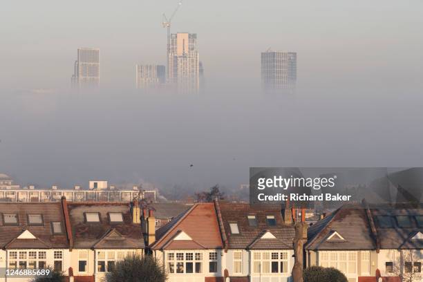 With Edwardian homes that border Ruskin Park in the foreground, morning fog partially obscures high-rise residential properties in the distance at...