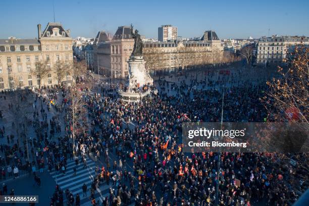 Demonstrators march through Place de la Republique at a protest during a national strike against government plans to revamp the pension system, in...