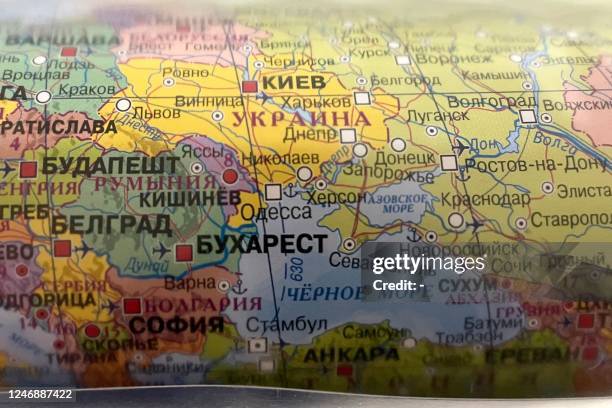 Picture taken on February 8, 2023 shows a political map of the world in a book store in Moscow. - Updated maps of Russia have started to go on sale...