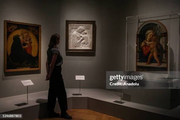 Member of staff poses with Donatello's sculpture 'Virgin and Child' by Pazzi Madonna, in Sainsbury Gallery at the Victoria and Albert Museum in...