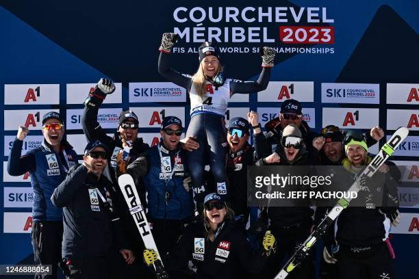 Tied for third-place, Norway's Kajsa Vickhoff Lie celebrates on the podium with team staff, after the Women's Super-G event of the FIS Alpine Ski...