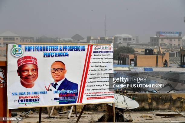 General view of a campaign billboard of candidate of New Nigeria Peoples Party Rabiu Kwankwaso and runningmate Bishop Isaac Idahosa displayed on roof...