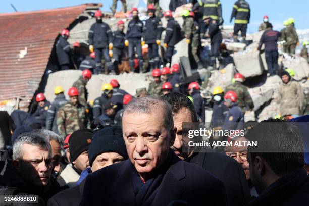 Turkish President Recep Tayyip Erdogan tours the site of destroyed buildings during his visit to the city of Kahramanmaras in southeast Turkey, two...