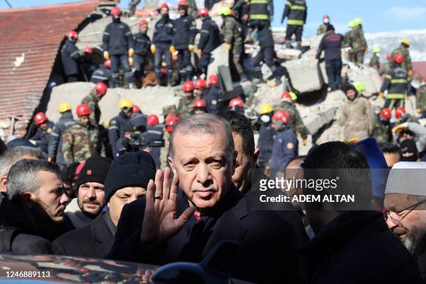 Turkish President Recep Tayyip Erdogan tours the site of destroyed buildings during his visit to the city of Kahramanmaras in southeast Turkey, two...
