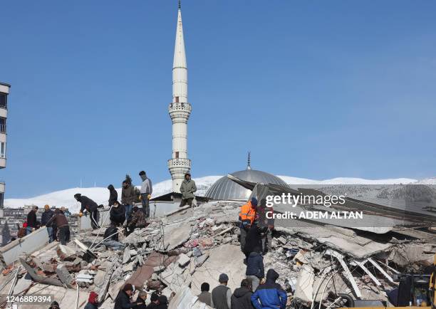 Rescuers and civilians look for survivors under the rubble of collapsed buildings in Kahramanmaras, close to the earthquake's epicentre, on February...