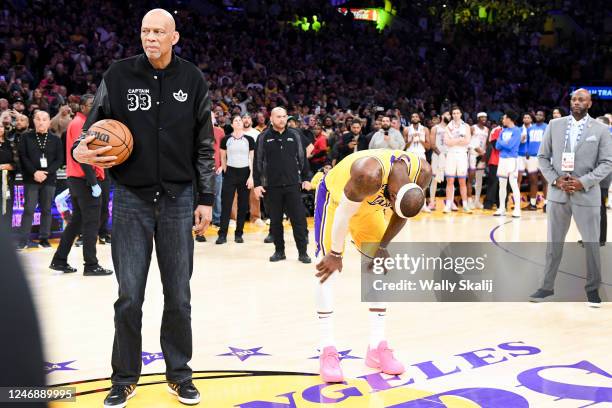 Los Angeles Lakers forward LeBron James reacts next to Kareem Abdul-Jabbar after making a shot to become the all-time NBA scoring leader, passing...