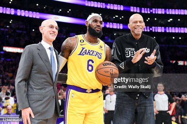 Adam Silver, from left, poses with LeBron James and Kareem Abdul-Jabbar, after James passes Kareem to become the all-time NBA scoring leader, passing...