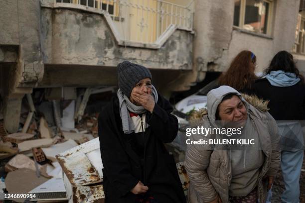 Women react in mourning next to rubble in Hatay, southeastern Turkey, on February 8 two days after a strong earthquake struck the region. - Searchers...