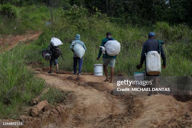 Alleged illegal miners leave an illegal mining area inside a Yanomami indigenous land in Roraima state, Brazil on February 7, 2023.