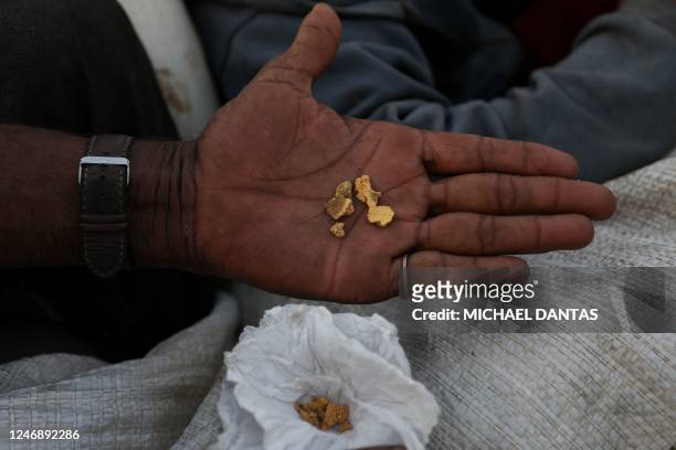 An alleged illegal miner shows a few grams of gold at an illegal mining area inside Yanomami indigenous land in Roraima state, Brazil on February 7,...